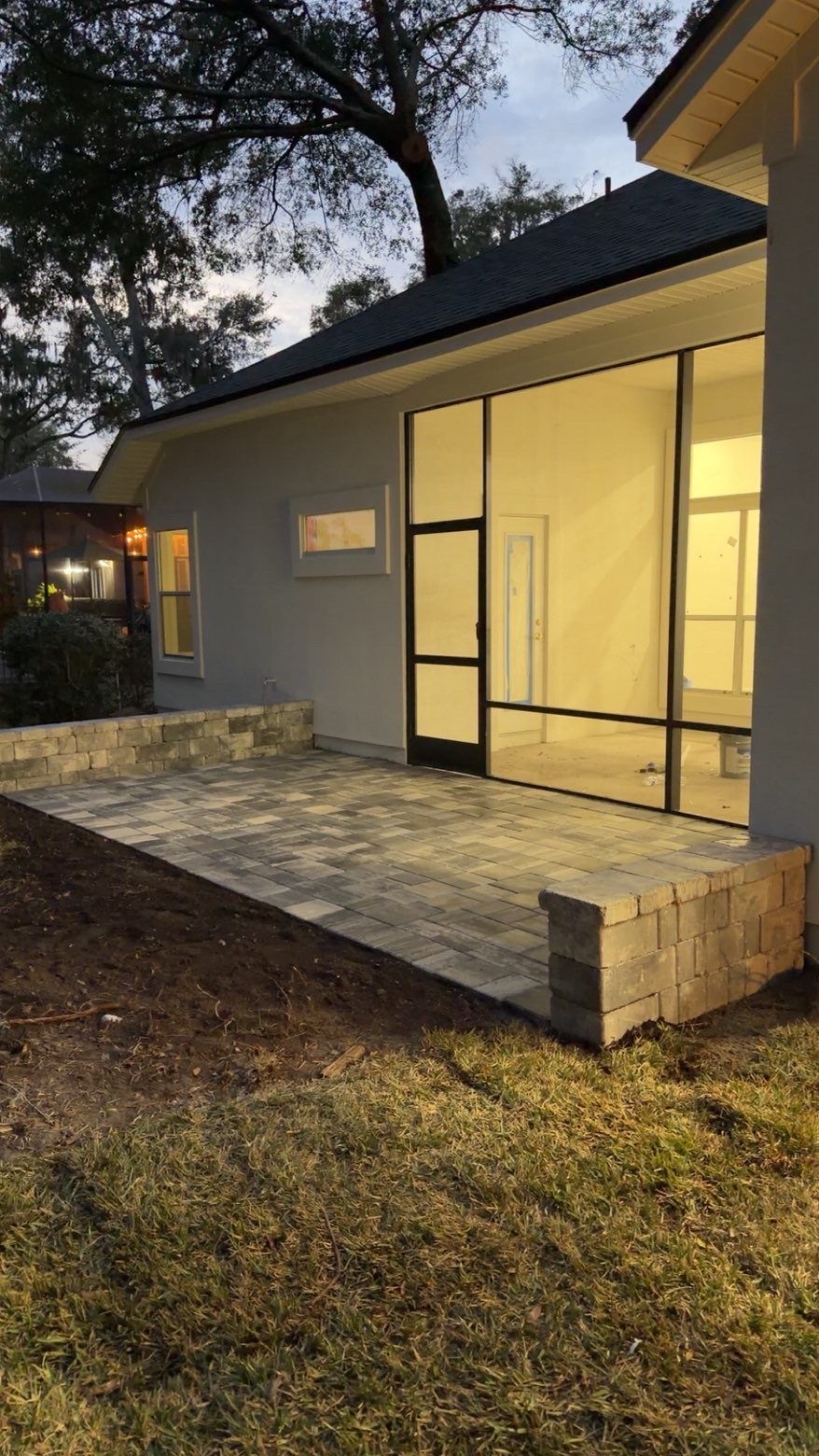 Custom paver patio with seat wall at residential home